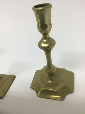 Lot 68 - Pair of early 18th century brass squat candlesticks, together with a similar taperstick