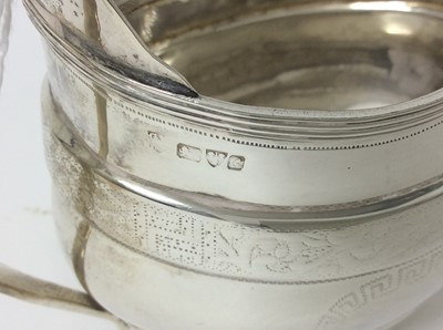 Lot 174 - Edwardian silver helmet-shaped cream jug in the Georgian style, with engraved Greek key and foliate borders (Chester 1903), 4.4ozs