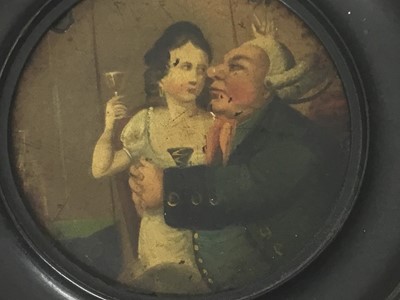 Lot 87 - Georgian lacquered painting of a gentleman attempting to seduce a woman, in an ebonised framed, the whole measuring 13cm diameter