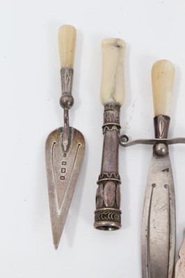 Lot 106 - Two Edwardian silver and mother of pearl trowel and sword book marks and other silver novelty items (7)