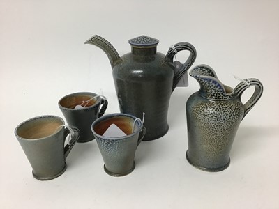 Lot 214 - Five pieces of Rebecca Harvey salt glazed studio pottery including coffee pot with lid, 16.5cm high, three cups, 7cm high and jug 13.5cm high