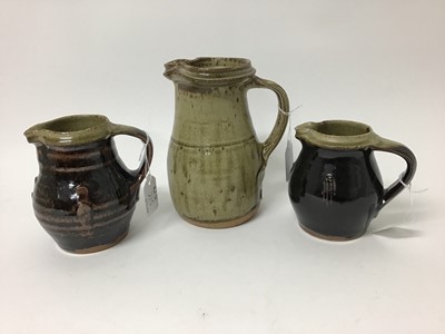 Lot 215 - Three Phil Rogers salt glazed studio pottery jugs, 18cm, 13.5cm and 12cm high (smaller two have monogram)