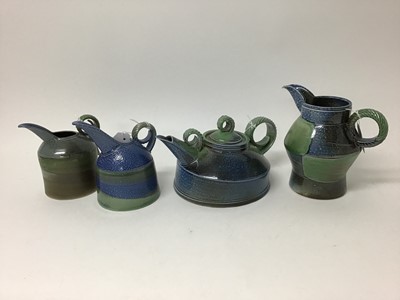 Lot 216 - Three Jane Hamlyn salt glazed studio pottery jugs, 17cm, 15cm and 13cm high plus a Jane Hamlyn teapot, all with monogram