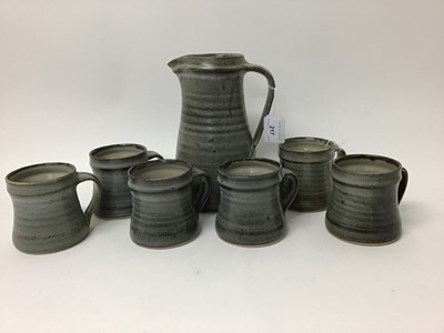 Lot 642 - St Ives studio pottery jug, 22cm high, and six St Ives pottery mugs, 9cm high