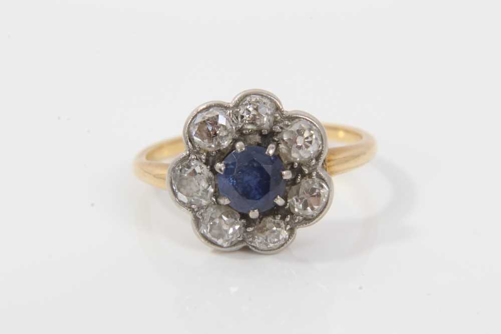 Lot 29 - Antique sapphire and diamond cluster ring with a flower head cluster centred with a round mixed cut blue sapphire measuring approximately approximately 5.2mm diameter surrounded by seven old cut di...