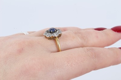 Lot 29 - Antique sapphire and diamond cluster ring with a flower head cluster centred with a round mixed cut blue sapphire measuring approximately approximately 5.2mm diameter surrounded by seven old cut di...