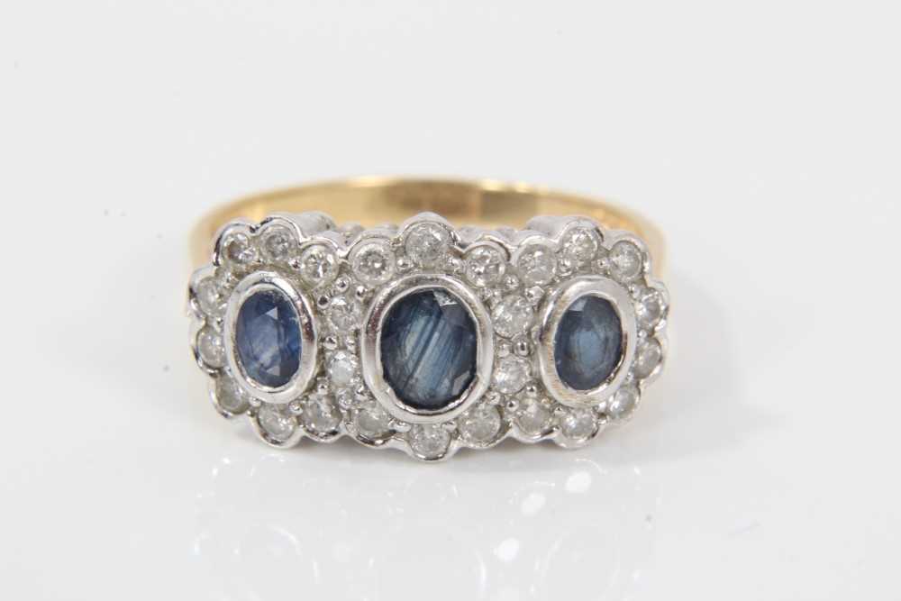Lot 30 - Sapphire and diamond triple cluster ring with three oval mixed cut blue sapphires surrounded by brilliant cut diamonds estimated to weigh approximately 0.50cts in total, on 18ct gold shank. Ring si...