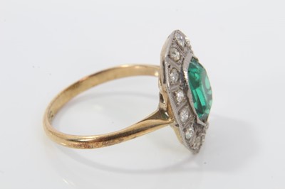 Lot 31 - 1920s diamond and green stone cocktail ring with a step cut green stone surrounded by a border of old cut and single cut diamonds, on 18ct gold shank. Ring size O½.