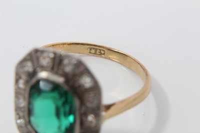 Lot 31 - 1920s diamond and green stone cocktail ring with a step cut green stone surrounded by a border of old cut and single cut diamonds, on 18ct gold shank. Ring size O½.