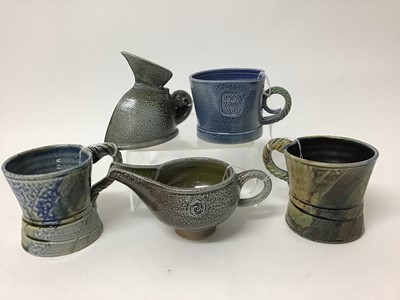 Lot 222 - Five salt glazed studio pottery items including Mark Compton jug, 11cm high, two Jane Hamlyn mugs, both 9cm high, another 7.5cm high and Mike Todd jug, 7cm high