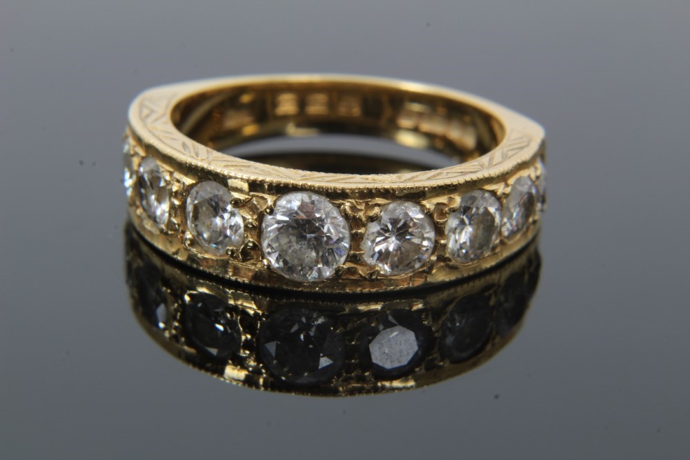 Lot 35 - Diamond nine stone ring with a half hoop of