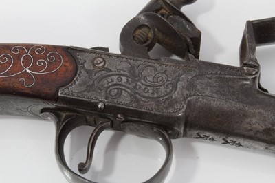 Lot 117 - Pair fine 18th century Queen Anne Flintlock pocket pistols with turn- off cannon barrels by Adams London , trigger guard safety's , fine silver wire inlaid walnut grips with grotesque mask but caps...