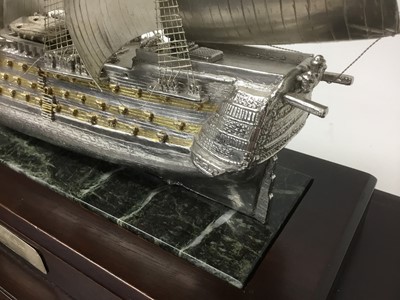 Lot 118 - H.M.S.Victory , a fine quality white metal and parcel gilt model of Nelsons famous flagship with fine detailing on marble and mahogany plinth in fine glazed mahogany case. The ship 42cm long, 35cm...