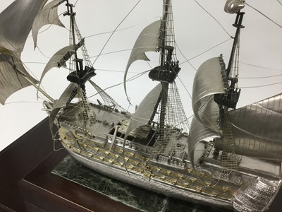 Lot 118 - H.M.S.Victory , a fine quality white metal and parcel gilt model of Nelsons famous flagship with fine detailing on marble and mahogany plinth in fine glazed mahogany case. The ship 42cm long, 35cm...