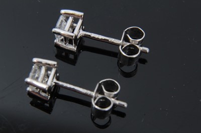 Lot 39 - Pair of diamond single stone earrings, each with a princess cut diamond in 18ct white gold four claw setting, hallmarked London 2004. Estimated total diamond weight approximately 0.40cts