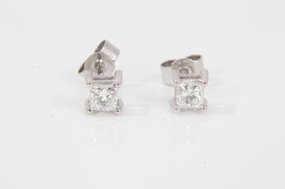Lot 39 - Pair of diamond single stone earrings, each with a princess cut diamond in 18ct white gold four claw setting, hallmarked London 2004. Estimated total diamond weight approximately 0.40cts