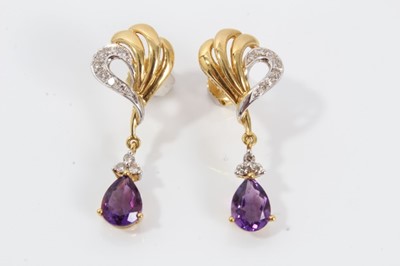 Lot 43 - Pair of 18ct gold diamond and amethyst pendant earrings with a pear cut amethyst surmounted by three diamonds suspended from a gold diamond-set scroll. 33mm