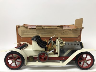 Lot 125 - Vintage Mamod steam roadster car with white coach work and red wheels , complete with steering extension rod and meths burner in original box . The car 39.5 cm long