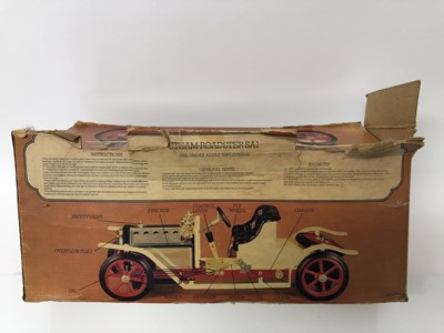Lot 125 - Vintage Mamod steam roadster car with white coach work and red wheels , complete with steering extension rod and meths burner in original box . The car 39.5 cm long