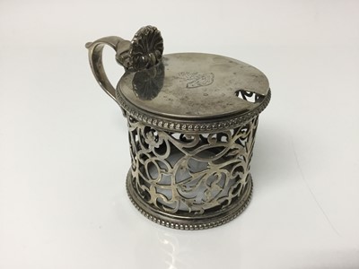 Lot 300 - Victorian silver mustard pot with pierced foliate body and beaded borders, hinged lid with engraved crest, by John Aldwinckle & Thomas Slater, (London 1889), 6.5cm high overall, 3.4ozs