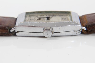 Lot 136 - Art Deco mid-size wristwatch with tonneau shape dial in chromium plated case on leather strap