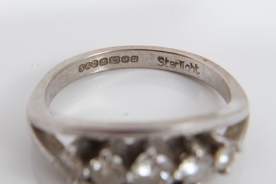 Lot 185 - Diamond five stone ring with five graduated brilliant cut diamonds in claw setting within a white gold border on plain shank. Signed 'Starlight', hallmarked Birmingham 1994, ring size Q½. Estimated...