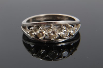 Lot 185 - Diamond five stone ring with five graduated brilliant cut diamonds in claw setting within a white gold border on plain shank. Signed 'Starlight', hallmarked Birmingham 1994, ring size Q½. Estimated...