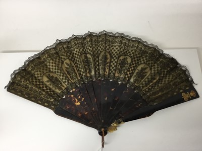 Lot 341 - 19th century tortoishell and black lace fan with yellow metal armorials and monograms to ends