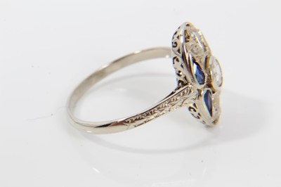 Lot 231 - Art Deco diamond and sapphire plaque ring with an oval openwork plaque with a central rose cut diamond, four pear cut blue sapphires (possibly synthetic) and rose cut diamonds, pierced gallery and...