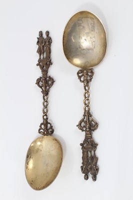 Lot 353 - Pair ornate 19th century Dutch silver gilt serving spoons with cast figure terminals and dolfin decoration 20 cm