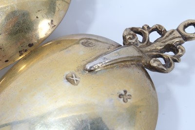 Lot 353 - Pair ornate 19th century Dutch silver gilt serving spoons with cast figure terminals and dolfin decoration 20 cm