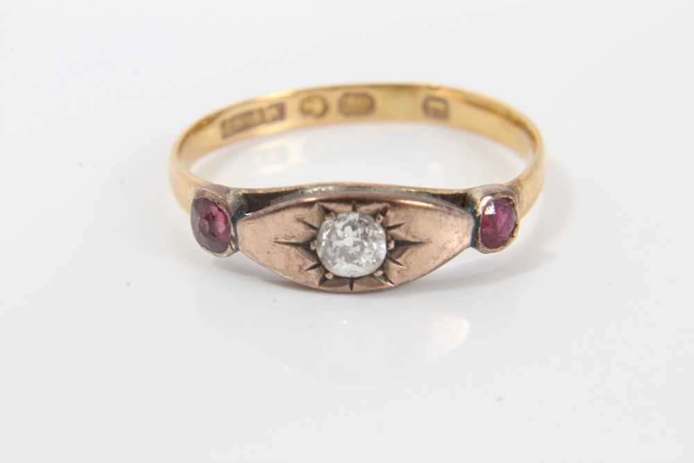 Lot 243 - Victorian diamond and ruby three stone ring with a central old cut diamond in gypsy-style setting flanked by two rubies in 9ct rose gold setting, possibly later mounted on a 22ct band, ring size O½