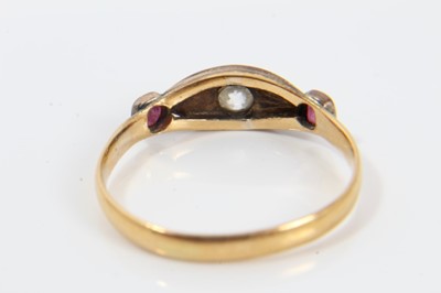 Lot 243 - Victorian diamond and ruby three stone ring with a central old cut diamond in gypsy-style setting flanked by two rubies in 9ct rose gold setting, possibly later mounted on a 22ct band, ring size O½