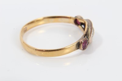 Lot 243 - Victorian diamond and ruby three stone ring with a central old cut diamond in gypsy-style setting flanked by two rubies in 9ct rose gold setting, possibly later mounted on a 22ct band, ring size O½