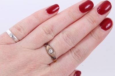 Lot 243 - Victorian diamond and ruby three stone ring with a central old cut diamond in gypsy-style setting flanked by two rubies in 9ct rose gold setting, possibly later mounted on a 22ct band, ring size O½