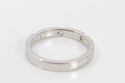 Lot 244 - Platinum and diamond half eternity style ring with three princess cut diamonds to the flat court shape platinum band. Ring size M½