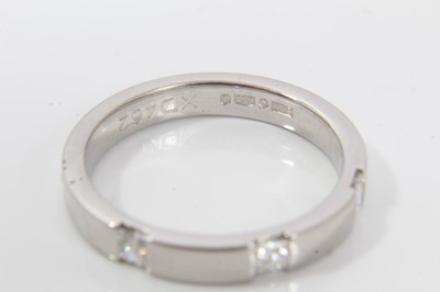 Lot 244 - Platinum and diamond half eternity style ring with three princess cut diamonds to the flat court shape platinum band. Ring size M½
