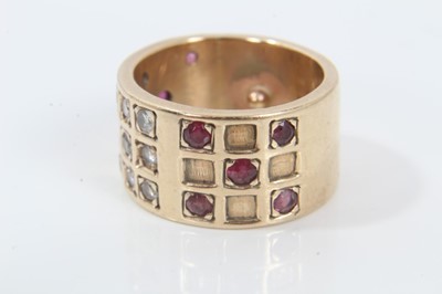Lot 245 - Diamond and ruby ring with a wide 9ct yellow gold band with brilliant cut diamonds and mixed cut rubies in a grid-style setting.