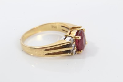 Lot 270 - 18ct gold diamond and red stone dress ring with an oval mixed cut red stone (possibly a synthetic ruby) flanked by six brilliant cut diamonds on 18ct gold shank. Ring size I½.