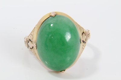 Lot 313 - Chinese green jade/hardstone ring with an oval jade cabochon measuring approximately 19mm x 14.5mm x 5.7mm, in 14ct gold setting, ring size P.
