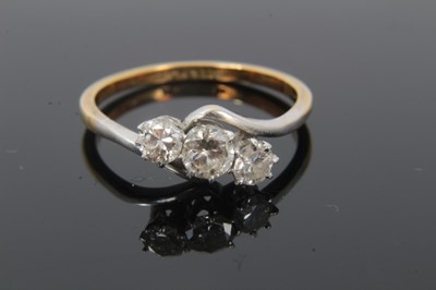 Lot 320 - Diamond three stone ring with three brilliant cut diamonds estimated to weigh approximately 0.55cts,in platinum claw cross-over setting on 18ct yellow gold shank. Ring size O.