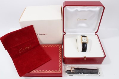 Lot 310 - Cartier 18ct gold Tank Quartz wristwatch, the rectangular white dial with black enamel Roman numerals and blued steel hands, in 18ct gold tank shaped case, cabochon blue sapphire to the crown, on C...