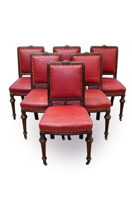 Lot 610 - Set of six Victorian walnut and close stud upholstered dining chairs, each with moulded framed and square pad back and seat on knopped fluted legs and castors