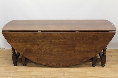 Lot 612 - Very large 17th century style oak double gateleg dining table, with elliptical drop leaf top on turned and block understructure, 210 x 220cm