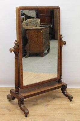 Lot 624 - Victorian mahogany cheval mirror, arched mirrored swing plate on finialled supports and sledge base with splayed feet and castors, 85cm wide