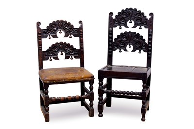 Lot 683 - Two Charles II oak Derbyshire back stools, each with twin carved horizontal splat and pendant and split pilaster ornament, on turned and block understructure, one with leather seat