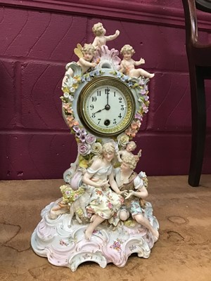 Lot 559 - Decorative china mantel clock with courting couple and cherubs and enamelled dial