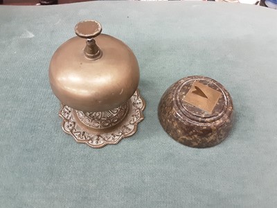 Lot 185 - Early 20th century serpentine sundial, corkscrew, vintage car badge and a brass desk bell (4)