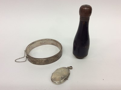 Lot 663 - Victorian silver bangle, white metal oval locket and a wooden needle case in the form of a champagne bottle