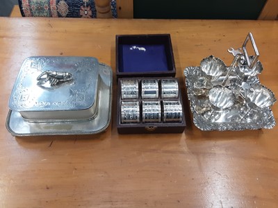 Lot 193 - Set of six good quality silver plated napkin rings in fitted case, plated sardine dish by Mappin & Webb, and other plated items